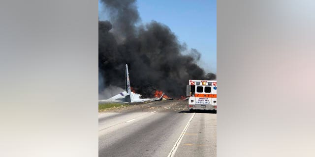 Flames and smoke rise from an Air National Guard WC-130 cargo plane after it crashed near Savannah, Ga., Wednesday, May 2, 2018.