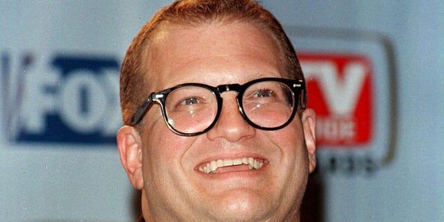 Actor Drew Carey poses with the TV Guide's Editors' Award he received because of his influence in shaping the quality of today's television programming at the first annual TV Guide Awards February 1 on the Fox Studio lot in Los Angeles. The awards were determined by readers of TV Guide magazine who voted for their favorite television shows and stars. - RTXIQDO