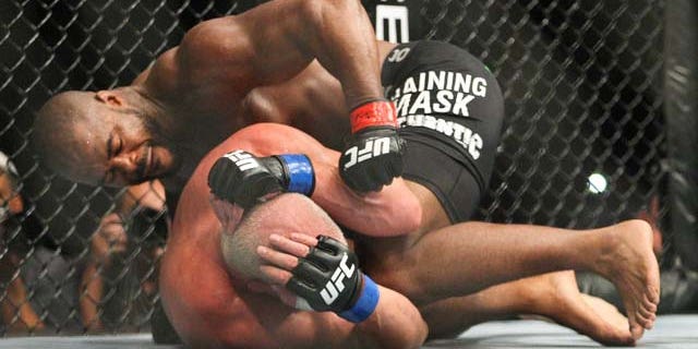 Rashad Evans, top, works against Tito Ortiz during a light heavyweight bout at UFC 133 on Saturday, Aug. 6, 2011, in Philadelphia. (AP Photo/The News-Journal, Suchat Pederson) NO SALES