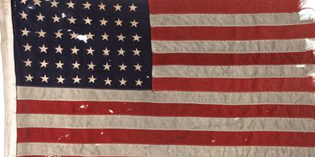 This undated photo provided by Heritage Auctions shows a U.S. flag flown on the stern of the boat that led the first American troops onto Utah Beach on D-Day.