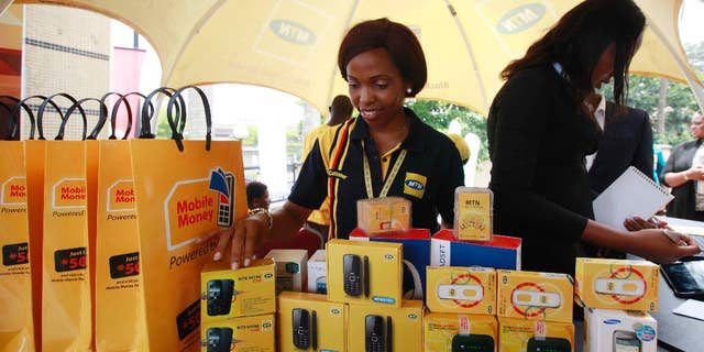 FILE- In this Monday April. 22, 2013 file photo, staff of MTN Nigeria workduring the launch of mobile number portability in Lagos, Nigeria. MTN Group telecommunication’s stock plunged 12.5 percent on the Johannesburg Stock Exchange Monday, Oct. 26, 2015 on the news that its most lucrative subsidiary, in Nigeria, has been fined $5.2 billion for failing to disconnect millions of unregistered cellphone subscribers.The Nigerian Communications Commission confirmed the penalty based on 200,000 naira ($1,000) for each of 5.1 million cellphone SIM cards that had not been registered and should have been disconnected by an August deadline. (AP Photo/Sunday Alamba file)