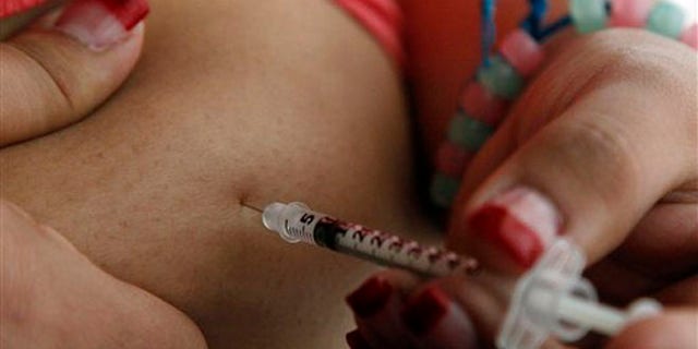 Judith Garcia, 19, gives herself an injection of insulin at her home in the Los Angeles suburb of Commerce, Calif., Sunday, April 29, 2012. A major study, released Sunday, tested several ways to manage blood sugar in teens newly diagnosed with diabetes and found that nearly half of them failed within a few years and 1 in 5 suffered serious complications. Garcia still struggles to manage her diabetes with metformin and insulin years after taking part in the study at Children's Hospital Los Angeles. (AP Photo/Reed Saxon)