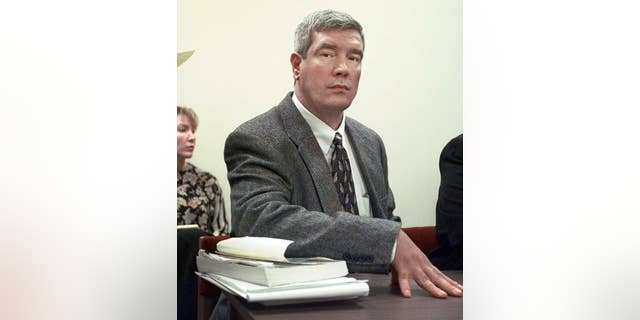 FILE - In this Feb. 8, 1999, file photo, Kerry Max Cook sits in a courtroom in Bastrop, Texas. Cook, a former death row inmate, says he wants to nullify an agreement his lawyers made that calls for his murder charge to be dismissed but also protects prosecutors from potential misconduct allegations. (AP Photo/LM Otero, File)