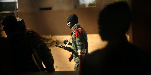 A Malian soldier walks in Gao, northern Mali, Thursday, Feb. 7, 2013. French troops began to withdraw from Timbuktu Thursday after securing the fabled city as they ramped up their mission in another northern Mali city, searching for Islamic extremists who may be mixing among the local population. (AP Photo/Jerome Delay)