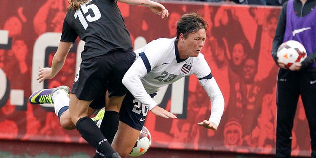 US Women's National Team's Abby Wambach (20) is tripped by New Zealand Women's National Team's Rebekah Stott (15) in the second half of an international friendly soccer match on Sunday, Oct. 27, 2013, in San Francisco. US won 4-1. (AP Photo/Tony Avelar)