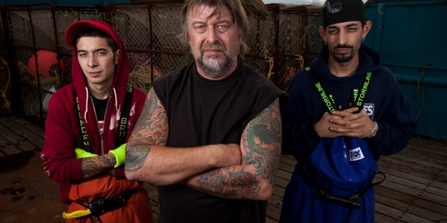 This file photo shows Cornelia Marie Captain Phil Harris (center) and his sons (from left to right) Deckhand Jake Harris and Deckhand Josh Harris in 2010.