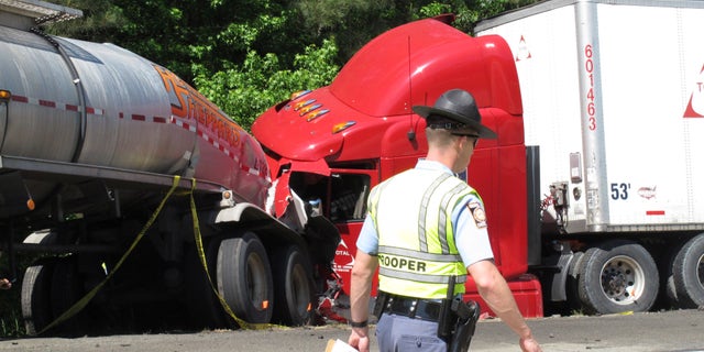 A Georgia state trooper works the scene of a deadly crash in April 2015.