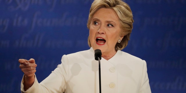 Democratic presidential nominee Hillary Clinton speaks to Republican presidential nominee Donald Trump during the third presidential debate at UNLV in Las Vegas, Wednesday, Oct. 19, 2016. (AP Photo/Patrick Semansky)