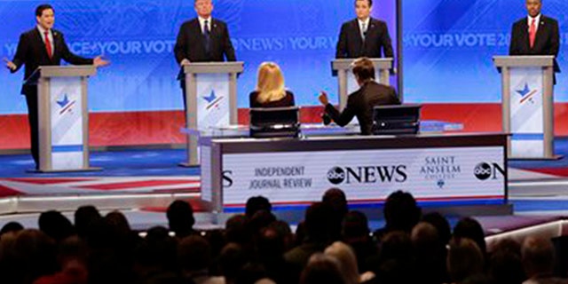 Republican presidential candidate, Sen. Marco Rubio, R-Fla., left, spars with Republican presidential candidate, New Jersey Gov. Chris Christie, right as Republican presidential candidate, businessman Donald Trump, Republican presidential candidate, Sen. Ted Cruz, R-Texas, and Republican presidential candidate, retired neurosurgeon Ben Carson listen during a Republican presidential primary debate hosted by ABC News at the St. Anselm College Saturday, Feb. 6, 2016, in Manchester, N.H. (AP Photo/David Goldman)
