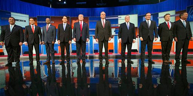 In this Aug. 6, 2015 photo, Republican presidential candidates from left, Chris Christie, Marco Rubio, Ben Carson, Scott Walker, Donald Trump, Jeb Bush, Mike Huckabee, Ted Cruz, Rand Paul, and John Kasich take the stage for the first Republican presidential debate of the 2016 election cycle, in Cleveland, Ohio. (AP Photo/Andrew Harnik, File) 