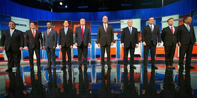 Republican presidential candidates from left, Chris Christie, Marco Rubio, Ben Carson, Scott Walker, Donald Trump, Jeb Bush, Mike Huckabee, Ted Cruz, Rand Paul, and John Kasich take the stage for the first Republican presidential debate at the Quicken Loans Arena, Thursday, Aug. 6, 2015,  in Cleveland. (AP Photo/Andrew Harnik)