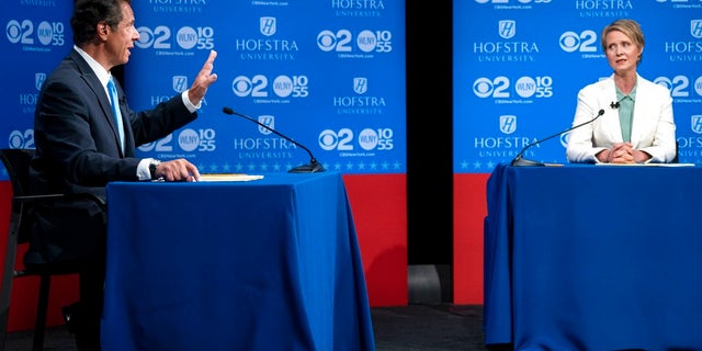 Cuomo answers a question at a debate last month as Cynthia Nixon looks on.