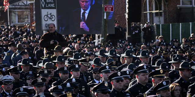 Dec. 27: Law enforcement officers turn their backs on a live video monitor showing New York City Mayor Bill de Blasio as he speaks at the funeral of slain New York Police Department officer Rafael Ramos near Christ Tabernacle Church in the Queens.