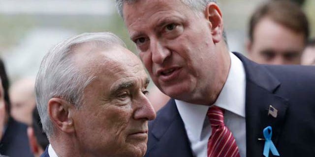 FILE 2014: New York City Police Commissioner Bill Bratton, left, and Mayor Bill de Blasio talk during memorial observances at the site of the World Trade Center in New York.