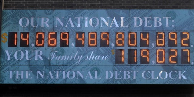 In this Feb. 14 photo, The National Debt Clock hangs from a building near Times Square in New York.