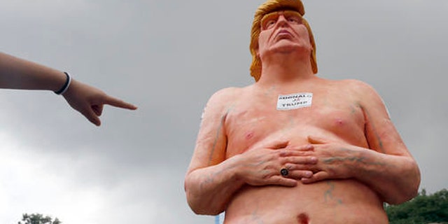 A statue of a naked Donald Trump.