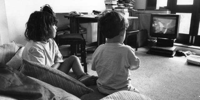 Two children watching a 'Tom And Jerry' cartoon on television, August 1995. (Photo by Steve Eason/Hulton Archive/Getty Images)