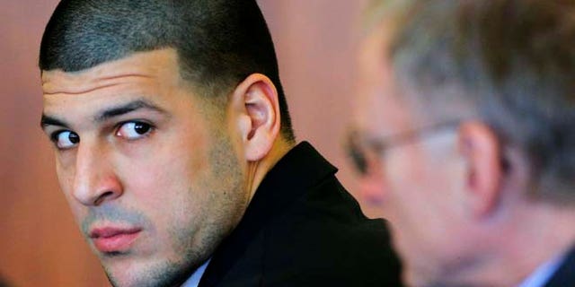 FILE 2014: Former New England Patriots tight end Aaron Hernandez, left, attends a pretrial hearing in Fall River, Mass.