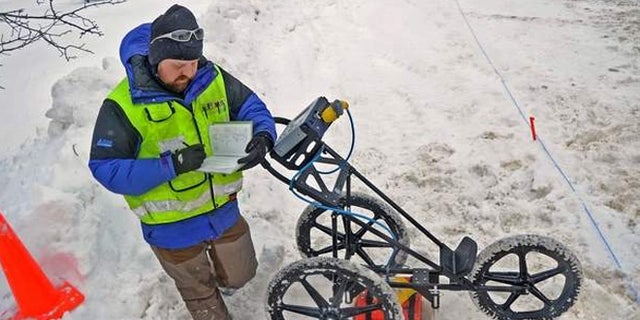 Seth A. Van Dam, a geophysical archaeologist takes notes while investigating potential Native American artifacts that could affect the creation of a new sewer district in Upstate New York
