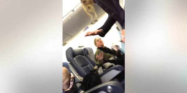 The woman was ultimately removed from the plane at the flight attendant's request. "You just screamed at a woman and her baby," the flight attendant told her.