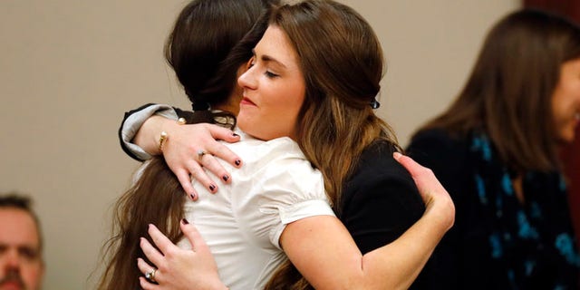 Rachael Denhollander, left, hugs Sterling Reithman, after Dr. Larry Nassar appeared in court for a plea hearing in Lansing, Mich., Wednesday, Nov. 22, 2017. Nasser, a sports doctor accused of molesting girls while working for USA Gymnastics and Michigan State University pleaded, guilty to multiple charges of sexual assault and will face at least 25 years in prison.