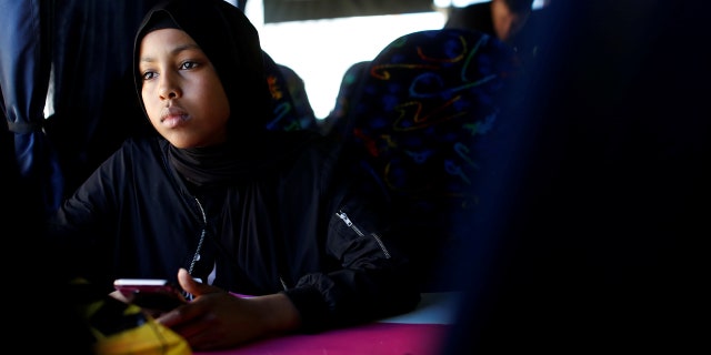 Ibtisam Ashur, a resident of Mjolnerparken which is a housing estate that features on the Danish government's "Ghetto List", rides a bus during an excursion to the seaside with "Sjakket", a youth group that provides activities and support for children that live in socially vulnerable areas of Copenhagen's north-west area in Denmark, May 9, 2018.