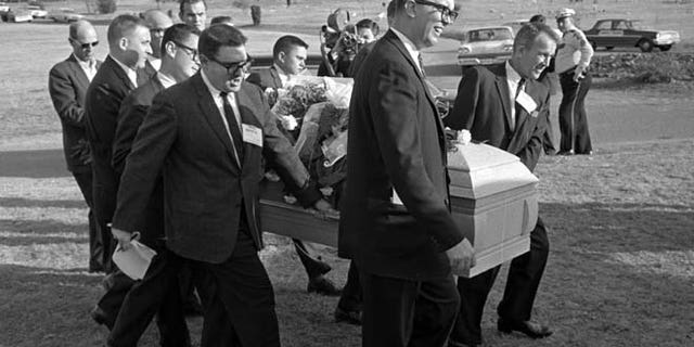 This file photo shows reporters that were enlisted to act as pall bearers at the interment of Lee Harvey Oswald at the Shannon Rose Hill Cemetery in Fort Worth, Texas.