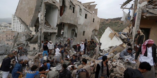 People search under rubble of a house destroyed by a Saudi-led air strike in Sanaa, Yemen, August 25, 2017.
