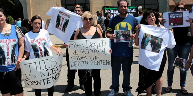 Chaldean-American Nadia Al-Raviah (C) stands with family members protesting against the seizure of her husband and brother Sunday by Immigration and Customs Enforcement agents during a rally outside the Mother of God Chaldean church in Southfield, Michigan.