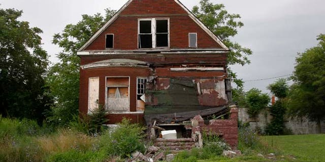 In this July 23, 2013 file photo, a vacant blighted home is seen on a street that was once lined with houses in Detroit, Michigan.