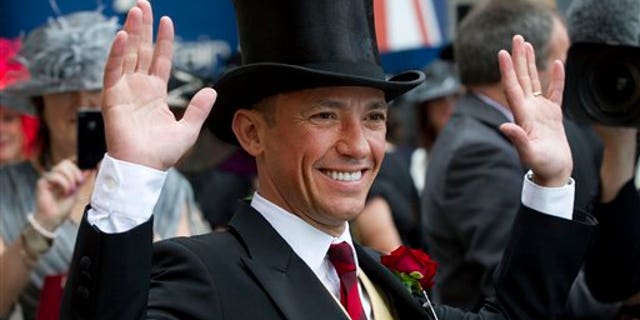 June 20, 2012: In this photo Italian jockey Frankie Dettori poses for the cameras on the second day of Royal Ascot horse race meeting at Ascot, England.