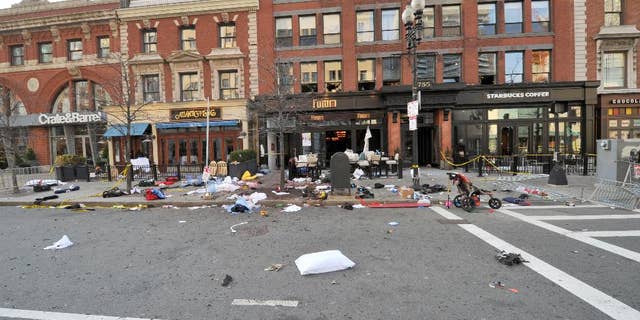 This April 15, 2013 forensics photograph made by the FBI, and provided Thursday, April 23, 2015, by the U.S. Attorney's office, and presented in federal court as evidence during the penalty phase of convicted Boston Marathon bomber Dzhokhar Tsarnaev's trial, shows the scene where the second bomb exploded on Boylston Street near the marathon finish line in Boston. Three people were killed and more than 260 others were wounded when twin bombs exploded. The prosecution rested its case Thursday during the penalty phase of Boston Marathon bomber Dzhokhar Tsarnaev's trial after playing a video showing a mother crouched over her 8-year-old son and resting her head on his chest as he lay dying. (U.S. Attorney's Office via AP)