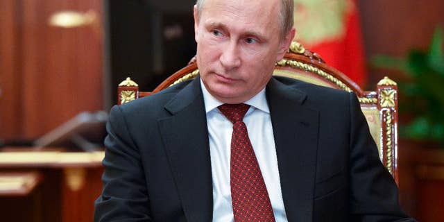Russian President Vladimir Putin meets with Russia's chief rabbi Berel Lazar and Chairman of Federation of Russia's Jewish Organizations Alexander Boroda in the Kremlin in Moscow, Russia, Wednesday, Dec. 17, 2014. (AP Photo/RIA-Novosti, Alexei Nikolsky, Presidential Press Service)