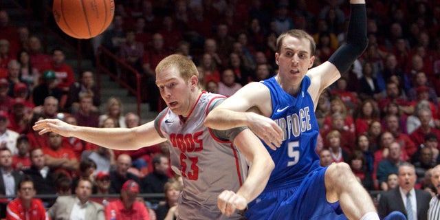 New Mexico's Alex Kirk, left, battles Air Force's Mike Fitzgerald for a loose ball in the first half of their NCAA college basketball game in Albuquerque, N.M., Wednesday, Feb. 6, 2013. (AP Photo/ Eric Draper)