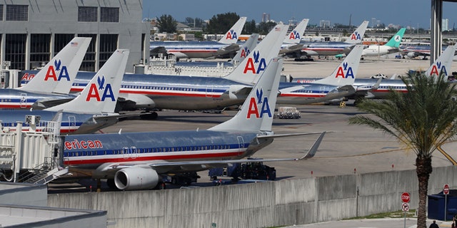 MIAMI, FL - APRIL 16: American Airlines planes are seen at their gates at Miami International Airport on April 16, 2013 in Miami, Florida. Thousands of American Airlines travelers became stranded today when the airline was forced to ground all its flights after a nationwide problem with its computer systems (Photo by Joe Raedle/Getty Images)