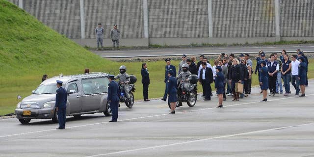 Relatives walk behind a hearse transporting a casket containing the remains of a LaMia flight crew victim to a waiting cargo plane at the military airbase in Rio Negro, Colombia, Friday, Dec. 2, 2016. An honor guard played taps early Friday as members of Colombia's military loaded the five flight crew victims of an air crash that also killed most members of a soccer team and a group of journalists, onto a cargo plane for the trip back to their native Bolivia. (AP Photo/Luis Benavides)