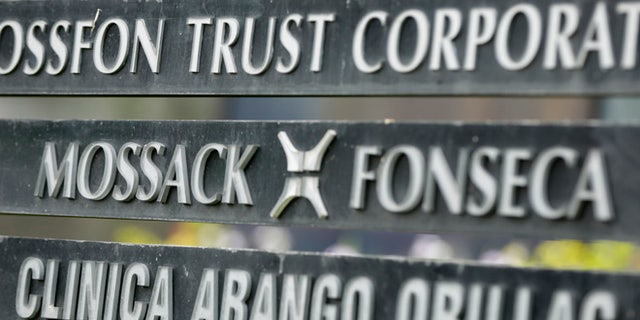 FILE - In this April 4, 2016 file photo, a marquee on a building in Panama City, Panama, lists the Mossack Fonseca law firm, one of the leaders in setting up offshore bank accounts for the rich and powerful. Offshore accounts conjure up images of malicious misdeeds, but many people use them for more than just hiding bribes and laundering money. And offshore accounts can be a financial tool for more than just the ultra-wealthy, too. (AP Photo/Arnulfo Franco, File)