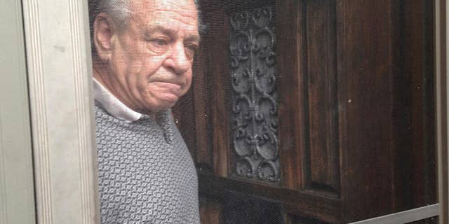Russell Yates stands at his front door talking to reporters following the arraignment of Liana Waldberg Wednesday, Jan. 18, 2017 in Warwick, R.I. Yates did not attend the arraignment hearing of Waldberg, his estranged wife, Wednesday morning. Elaine Yates officially changed her name to Liana Waldberg in 2009. (AP Photo/Jennifer McDermott)