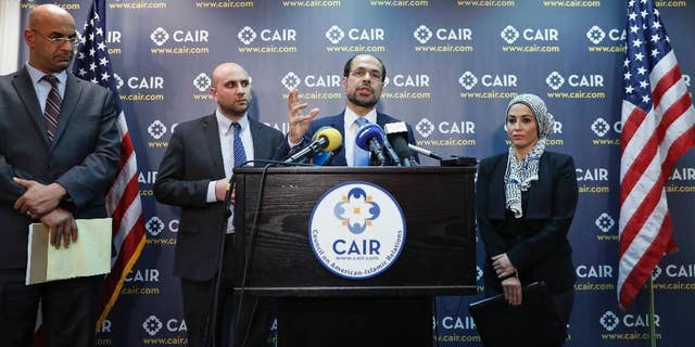 Attorneys Shereef Akeel, left, Gadeir Abbas, and Lena F. Masri, right, stand as Council on American-Islamic Relations (CAIR) national executive director Nihad Awad speaks during a news conference at the Council on American-Islamic Relations (CAIR), Monday, Jan. 30, 2017 in Washington.