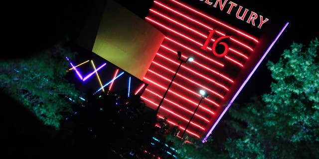 FILE - In this Friday, July 20, 2012 file photo, the neon sign over the Century 16 theatre burns bright in the night east of the Aurora Mall in Aurora, Colo. The theatre was the scene of a bloody rampage in which 12 people died and 70 were injured during a bloody assault at the July 20, 2012 midnight premiere of "The Dark Knight." On Monday, May 9, 28 victims' families will argue that Century Theatres should be held accountable for not doing more to prevent the slaughter in its property. (AP Photo/David Zalubowski, file)