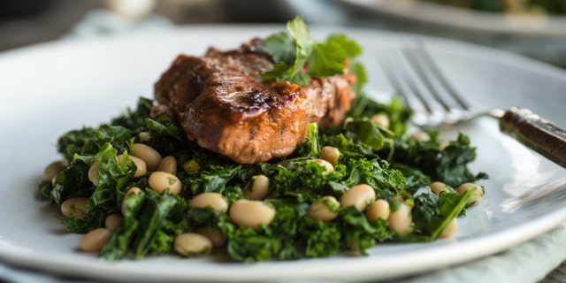 Lamb on sauteed kale with white beans and cilantro