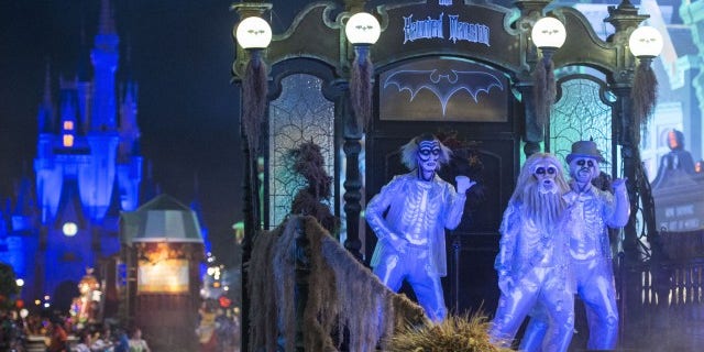 Haunted Mansion characters come to play during the parade.