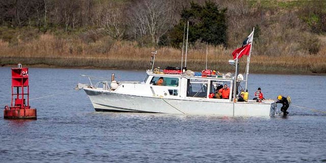 FILE 2015: Divers prepare to descend onto the wreck site of the CSS Georgia near the channel of the Savannah River, Savannah, Ga. The recovery of the Confederate ironclad ship marks the beginning of the construction phase of the Savannah Harbor Expansion Project.