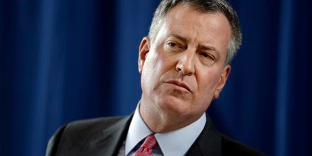 FILE - In this Feb. 25, 2014 file photo, New York City Mayor Bill de Blasio listens to a question during a news conference at P.S. 130 in New York.