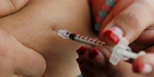April 29, 2012: In this file photo a woman diagnosed with diabetes gives herself an injection of insulin at her home in the Los Angeles suburb of Commerce, Calif.