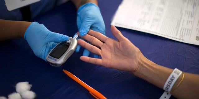 A person receives a test for diabetes during Care Harbor LA free medical clinic in Los Angeles, California September 11, 2014. REUTERS/Mario Anzuoni