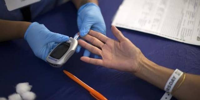 Sept. 11, 2014: A person receives a test for diabetes during Care Harbor LA free medical clinic in Los Angeles, California.