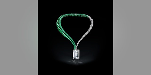 In this image released on Thursday, Sept. 28, 2017, a diamond necklace featuring a 163-carat flawless emerald stone, the largest of its kind ever to be put up for auction, has been unveiled in Hong Kong today. The finished piece, named The Art of de Grisogono will be presented in a series of public viewings around the world before it goes up for an auction at Christie's in Geneva on November