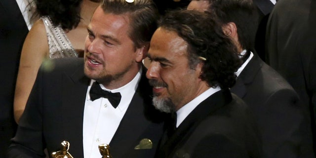 Director Alejandro Inarritu (R) and actor Leonardo DiCaprio hold their Oscars after the end of the awards ceremony at the 88th Academy Awards in Hollywood, California February 28, 2016. REUTERS/Mario Anzuoni TPX IMAGES OF THE DAY - RTS8HAU