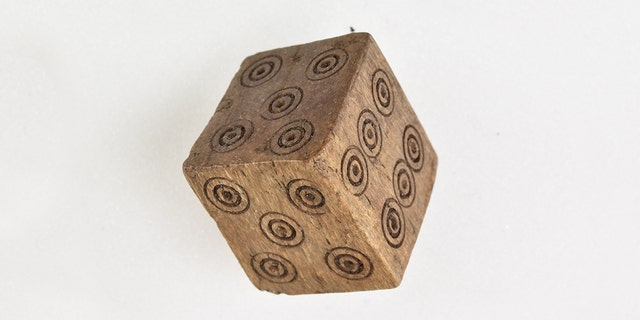 The apparently loaded dice have two fives and two fours, instead of the numbers one and two.